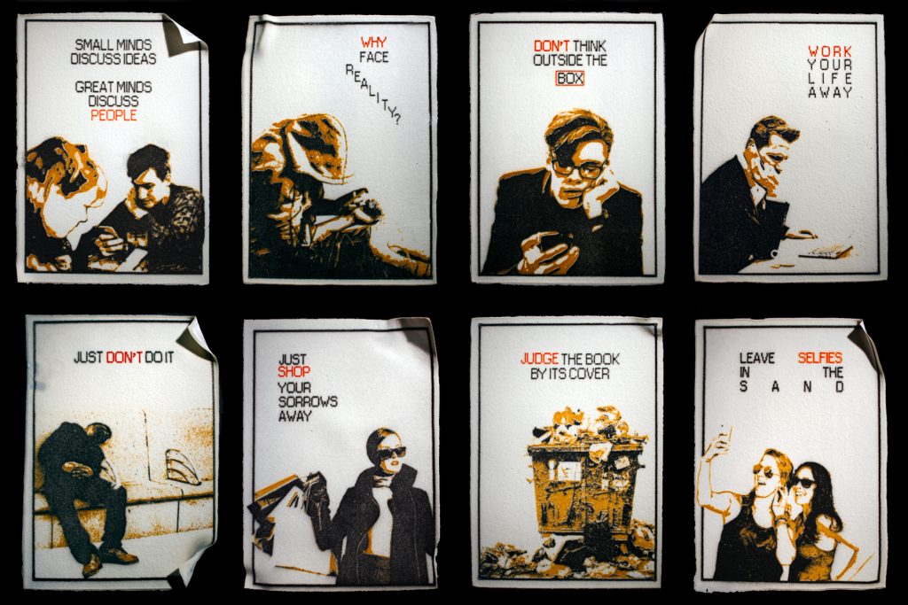 Art piece "Something" in 2018 by Alise Stopina. Paper colored eight glass powder with printed satirical quotes and images related to quotes.